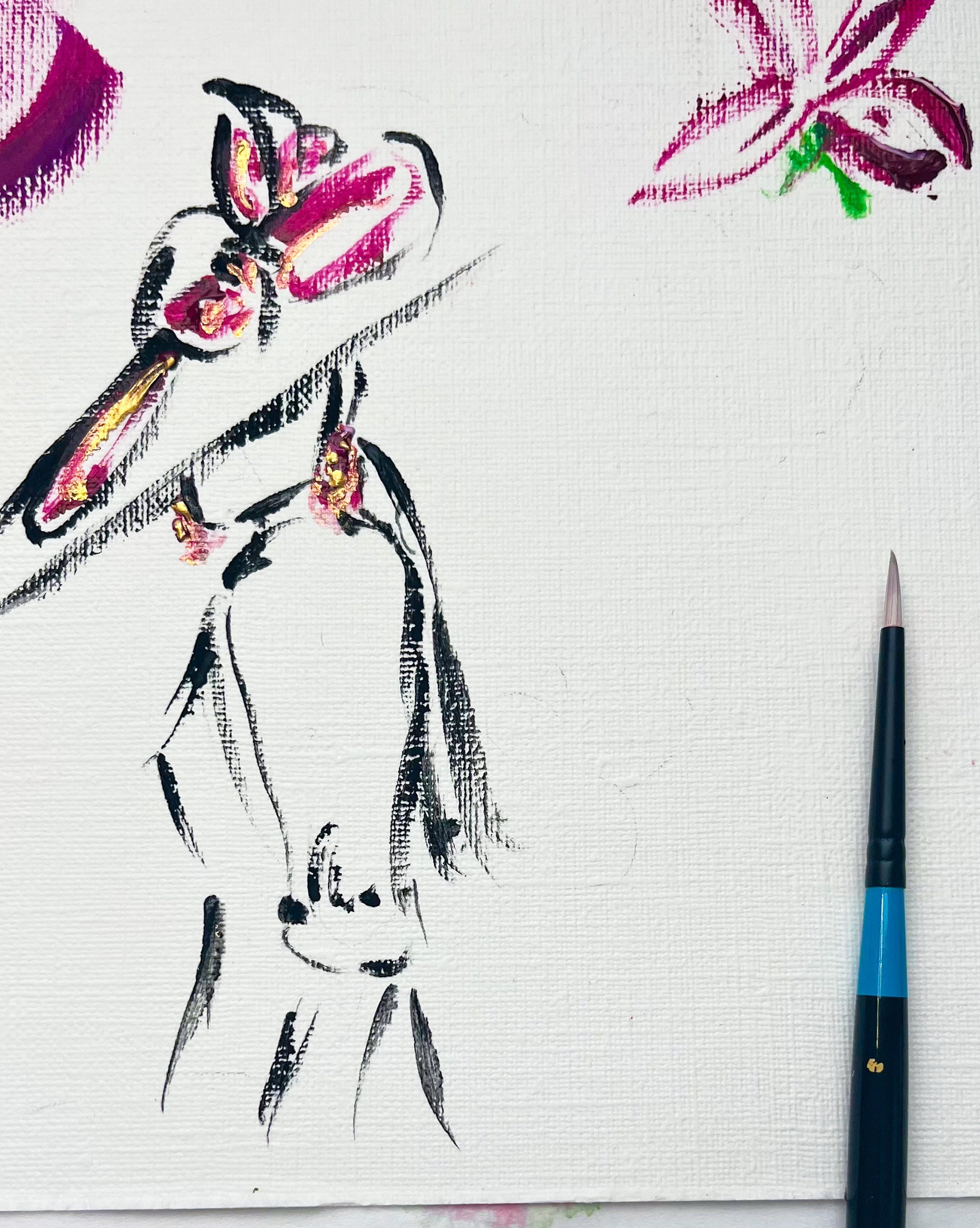 A close-up of a textured white canvas showing a partial black ink sketch of a woman in a pink hat, with a paintbrush on the right and paint drips at the bottom.