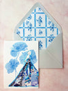 Greeting card with floral design and envelope on a pink background