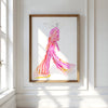 Framed artwork of a colorful dress on a white wall with natural light.