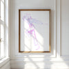 Framed abstract artwork on a white wall with natural light