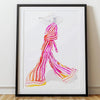 Framed artwork of a colorful abstract design on a white wall.
